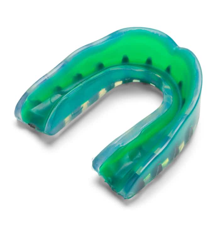 Bright green and blue sports mouthguard with a U-shape, used for dental protection during physical activities like martial arts, football, and hockey.